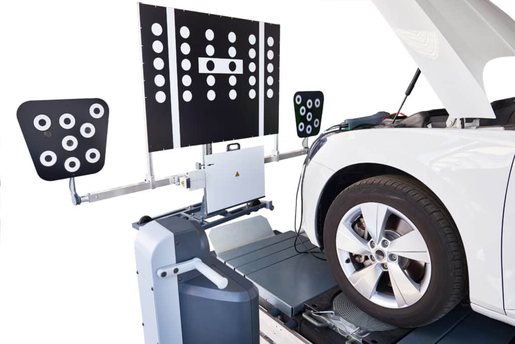 ADAS Calibration Services in Merriam, KS at Done With Care Auto Repair. Image of A white car undergoing ADAS calibration inside the Done With Care Auto Repair shop in Merriam, KS.