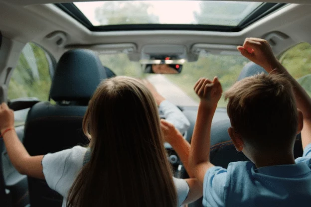 Summer Road Trip Inspection Service at Done With Care Auto Repair, Merriam, KS. Image of children having fun in the backseat of a car, highlighting the importance of a comprehensive vehicle inspection for a safe and enjoyable journey.