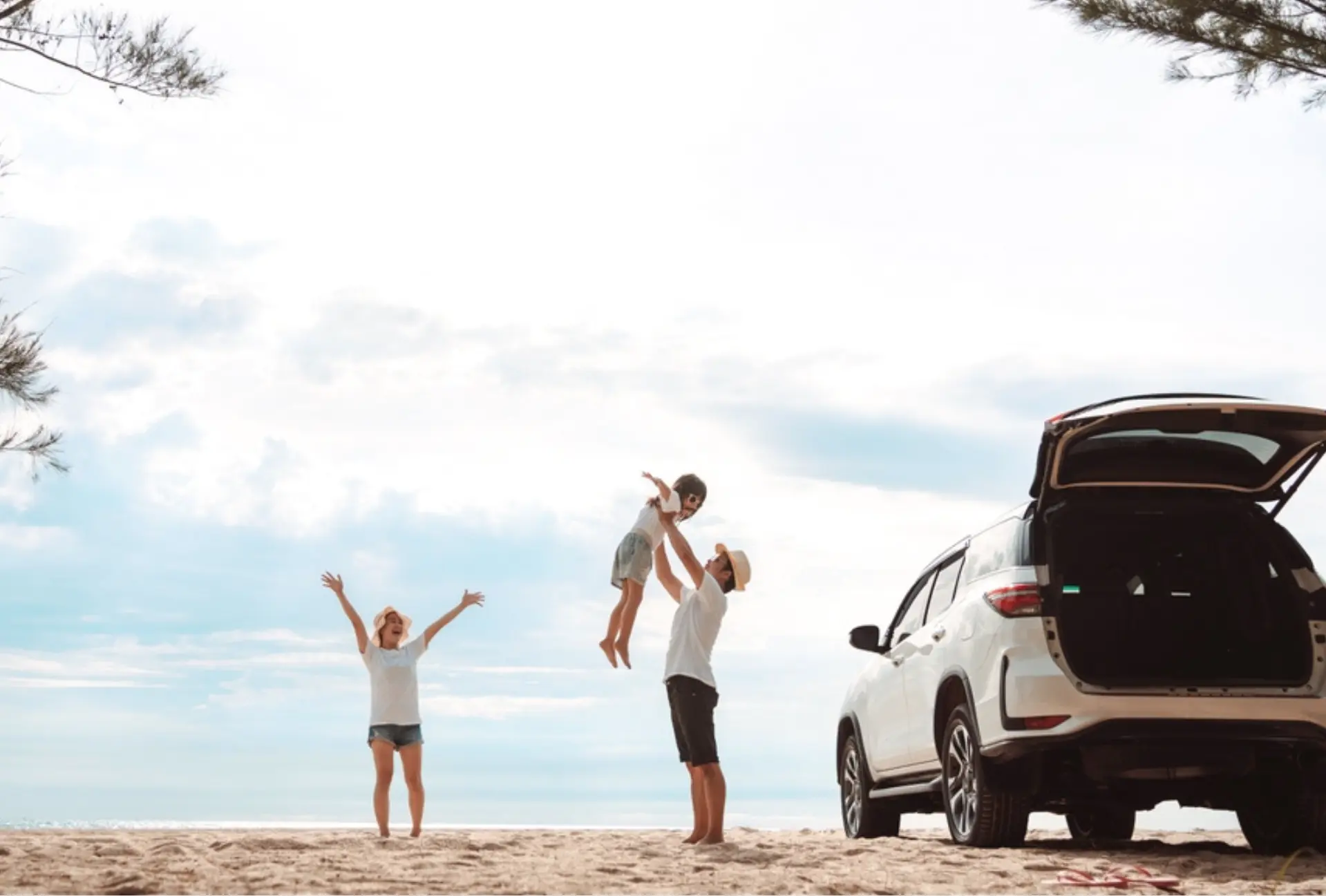 Summer road trip preparation in Merriam, KS by Done With Care Auto Repair. A family enjoying a day at the beach with their car, symbolizing the importance of ensuring your vehicle is in top shape for safe and enjoyable summer adventures.