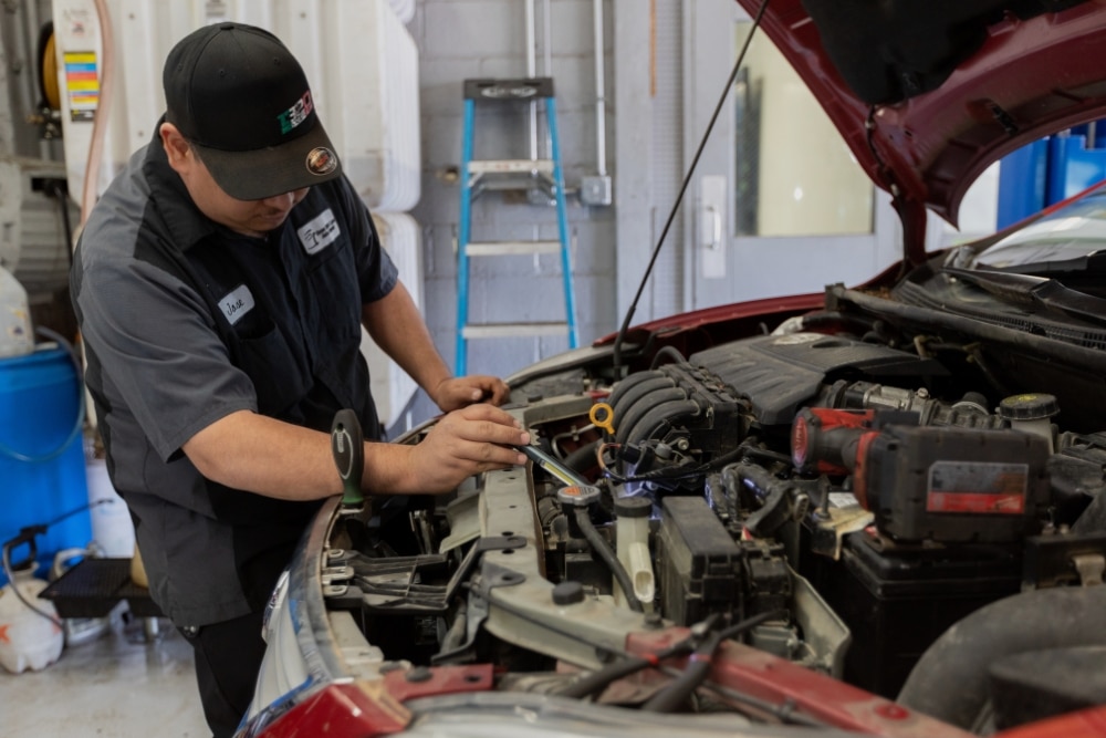Merriam Drivers Trusted Auto Repair, Auto Repair Service in Merriam KS At Done With Care Auto Repair. Mechanic inspecting a car engine in auto repair shop.