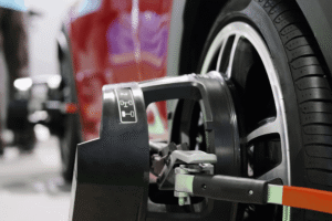 Tire rotation and wheel alignment in Merriam, KS at Done With Care Auto Repair. Image of a wheel alignment sensor attached to a vehicle wheel to support even tire wear and proper handling.