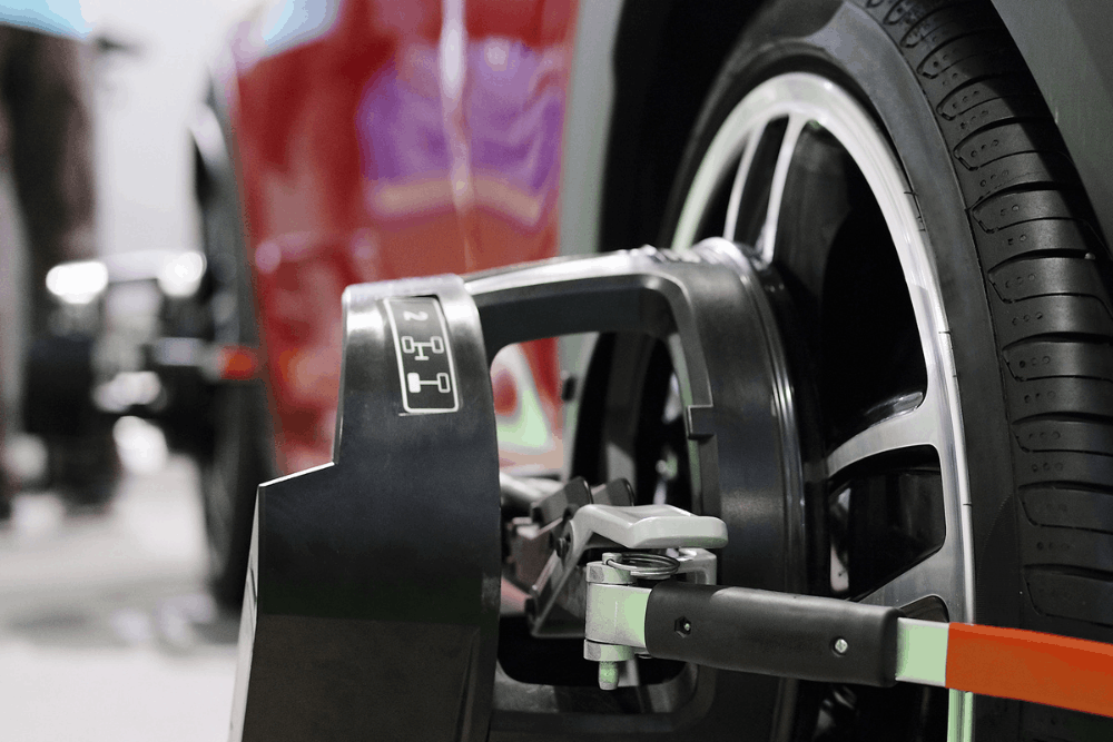 Tire rotation and wheel alignment in Merriam, KS at Done With Care Auto Repair. Image of a wheel alignment sensor attached to a vehicle wheel to support even tire wear and proper handling.