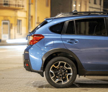 Which brand is better - subaru or kia? Subaru and Kia repair services in Merriam, KS with Done With Care. Image of blue subaru hatchback car parked on a night street.