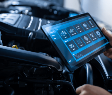 car diagnostic test, auto repair in Merriam, KS at Done With Care Auto Repair. Image of a mechanic using a digital tablet for engine diagnostics.